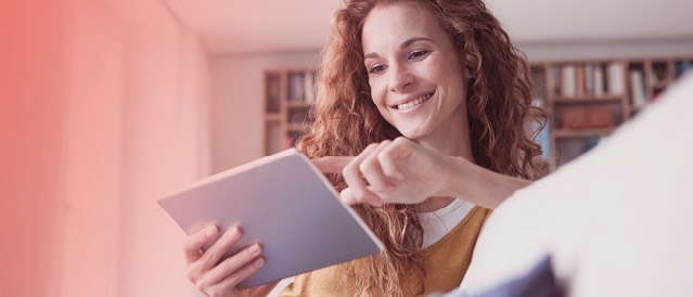 Woman holding tablet sitting on a lounge