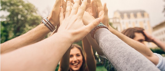 Group of people high fiveing