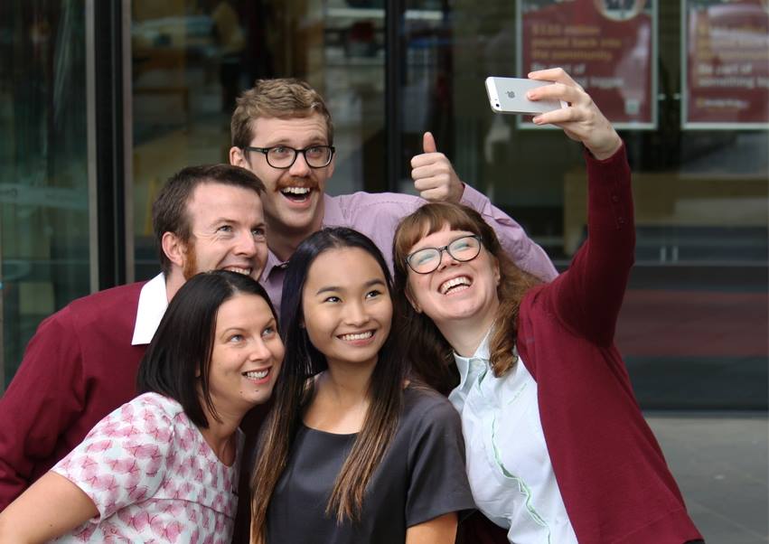 Five staff members in the old Bendigo Bank uniform taking a selfie together.